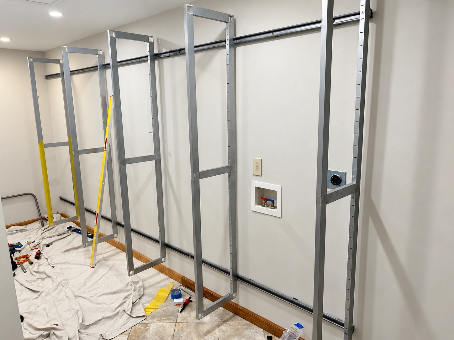 Actual installation before shelving: open aluminum blade frames mounted to two horizontal wall tracks